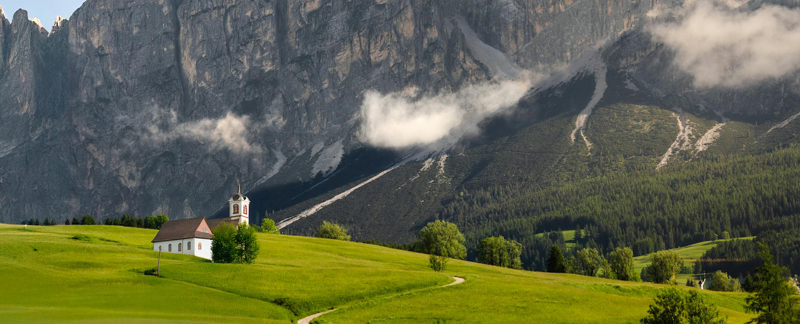 free photo of scenic church and mountain landscape in the dolomites