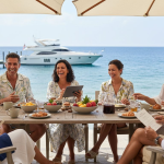 Friends enjoying luxury group seaside brunch