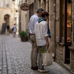 Travelers exploring authentic local European street