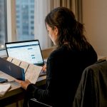 Business traveler checking travel prices in hotel