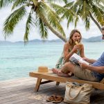 Couple relaxing on private island villa deck