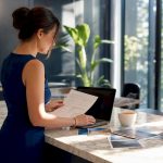 Travel planner working on itinerary at desk