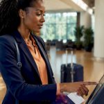 Traveler using airport check-in kiosk