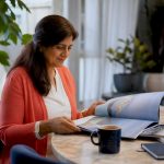 Woman planning concierge cruise at home desk