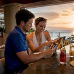 Couple planning honeymoon outdoors in tropical setting