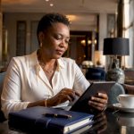 Woman planning luxury group travel on tablet