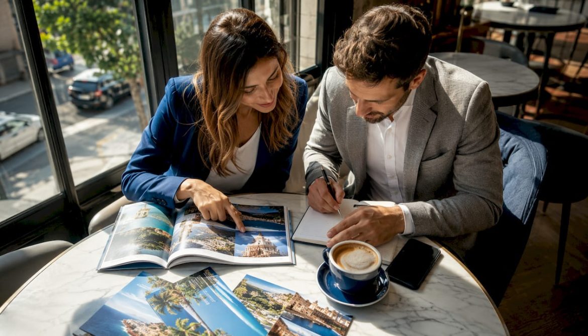 Couple planning honeymoon with brochure and planner