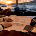 Hands examining cruise ship deck plan