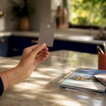 Hand holding unbranded credit card