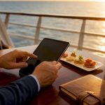 Hands planning cruise itinerary on cruise ship veranda