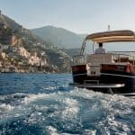 Private boat passing Amalfi Coast cliffs