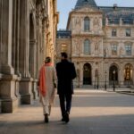 Couple walking through Paris museum courtyard