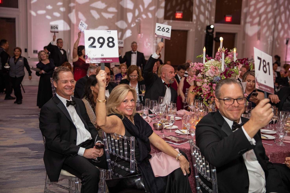 Guests attending an elegant charity gala fundraising event