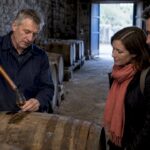 Guide sampling whisky from a warehouse cask