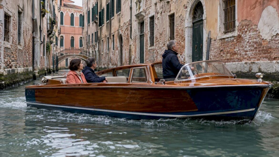 Private wooden launch traveling through Venice canal