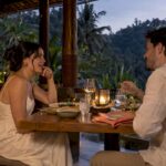 Couple sharing dinner at a Bali pavilion