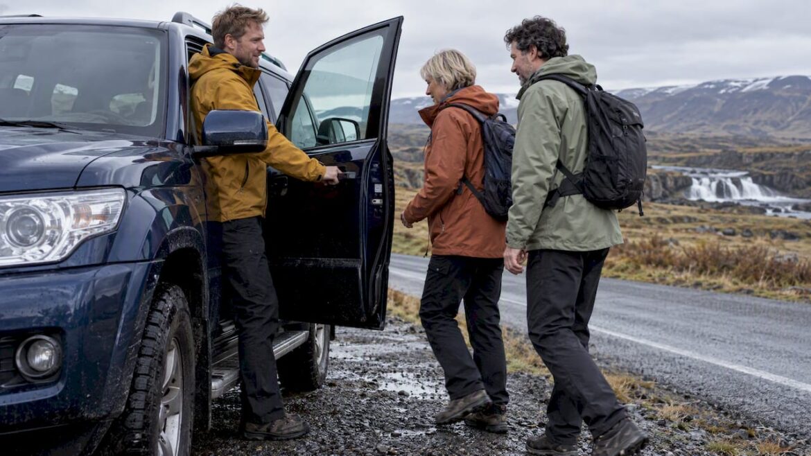 Private guide welcoming guests to an Iceland tour vehicle